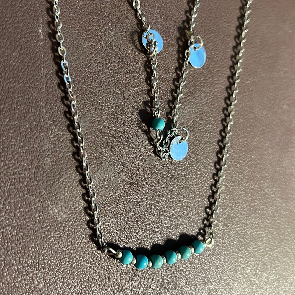 Double stranded necklace on a triple rhodium plated band